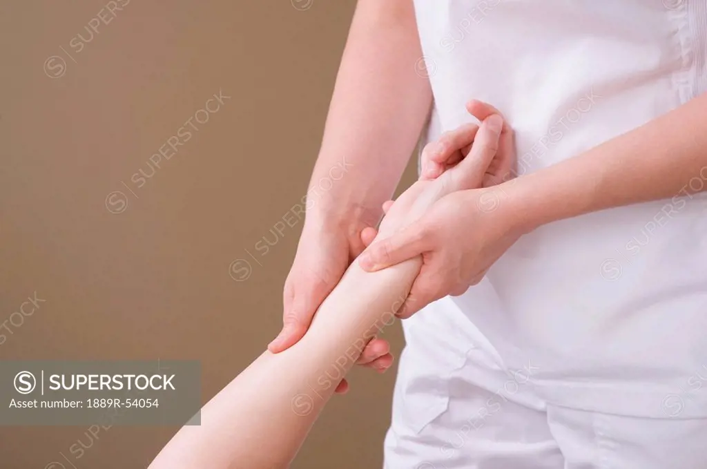 an arm being massaged by a massage therapist