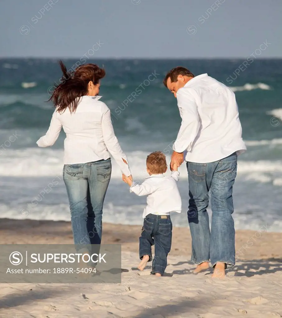 Fort Lauderdale, Florida, United States Of America, A Family Walking On The Beach