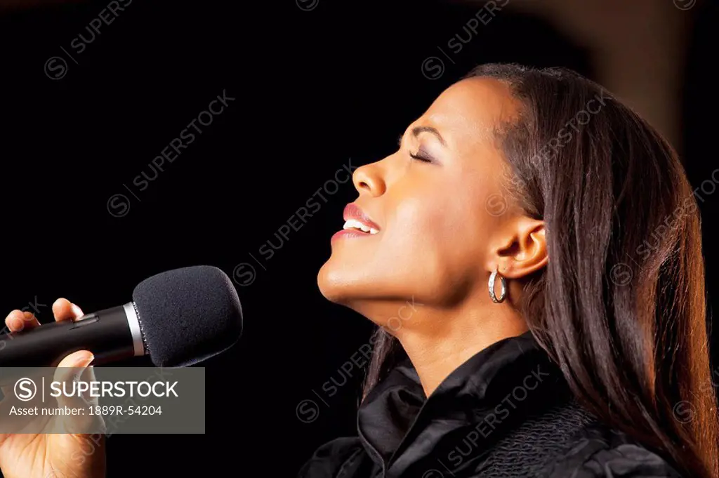 Fort Lauderdale, Florida, United States Of America, A Woman Singing Into A Microphone