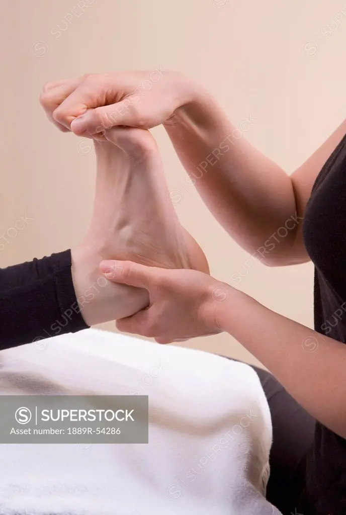 A Foot Being Worked On By A Massage Therapist