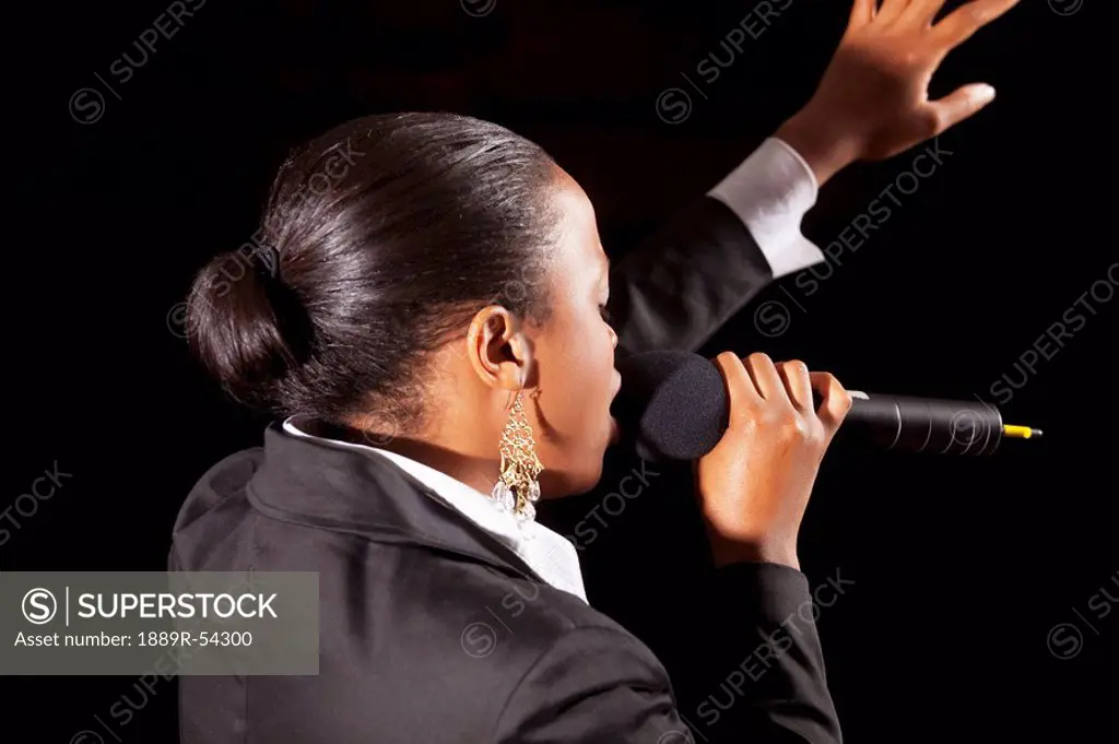 Fort Lauderdale, Florida, United States Of America, A Woman Singing Into A Microphone And Leading Worship