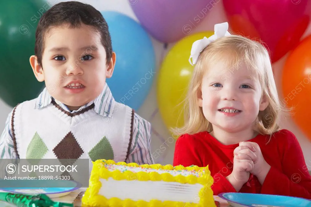 Knoxville, Tennessee, United States Of America, Two Children With Balloons And A Birthday Cake