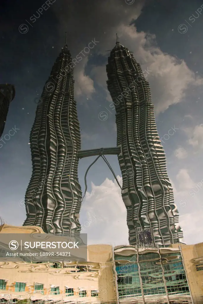 kuala lumpur, malaysia, reflection of two tall buildings in water