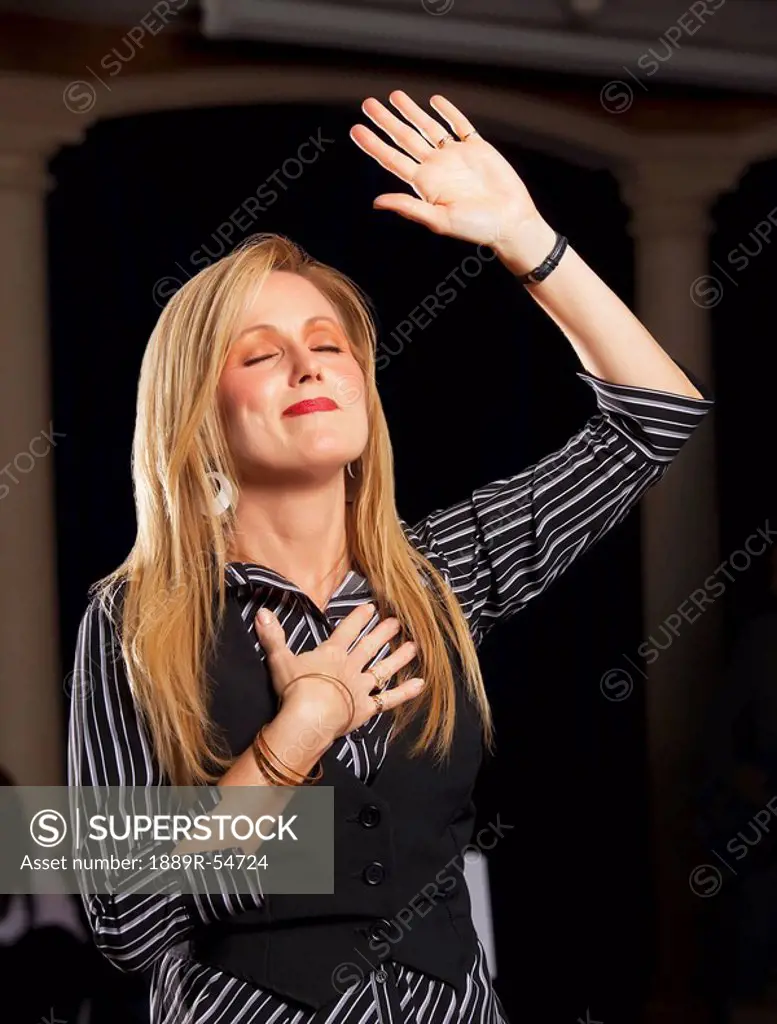 Fort Lauderdale, Florida, United States Of America, A Woman With Her Hand Raised In Worship