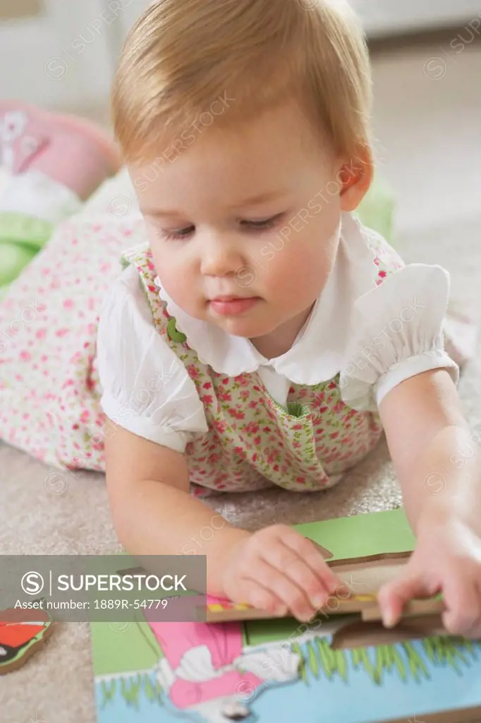 Knoxville, Tennessee, United States Of America, A Young Girl Playing With A Wooden Puzzle