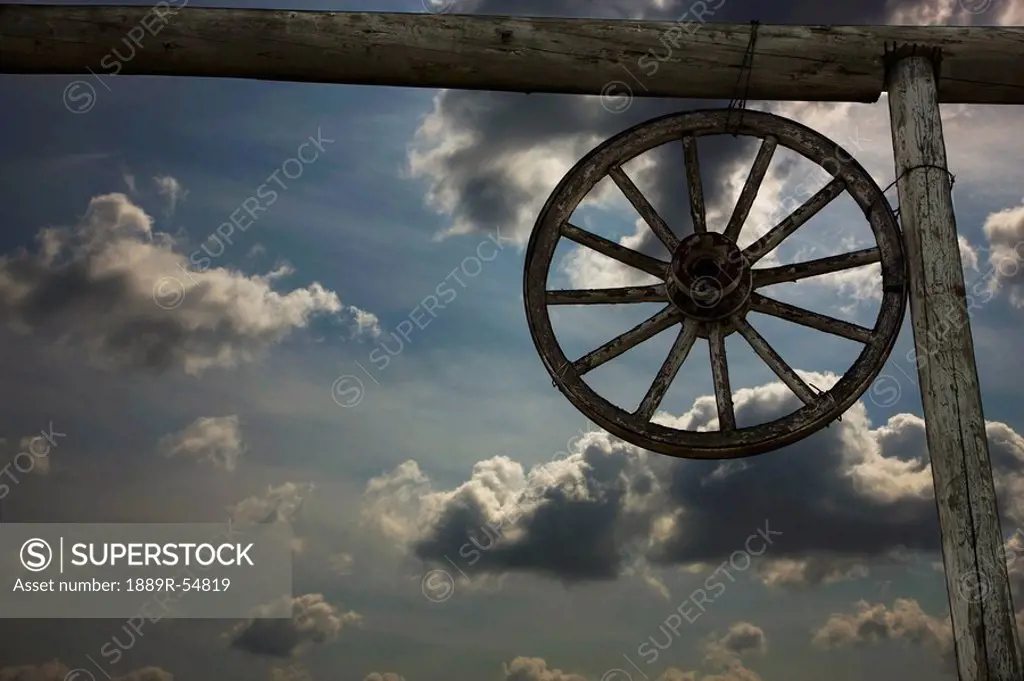 Alberta, Canada, A Wagon Wheel And An Old Fence