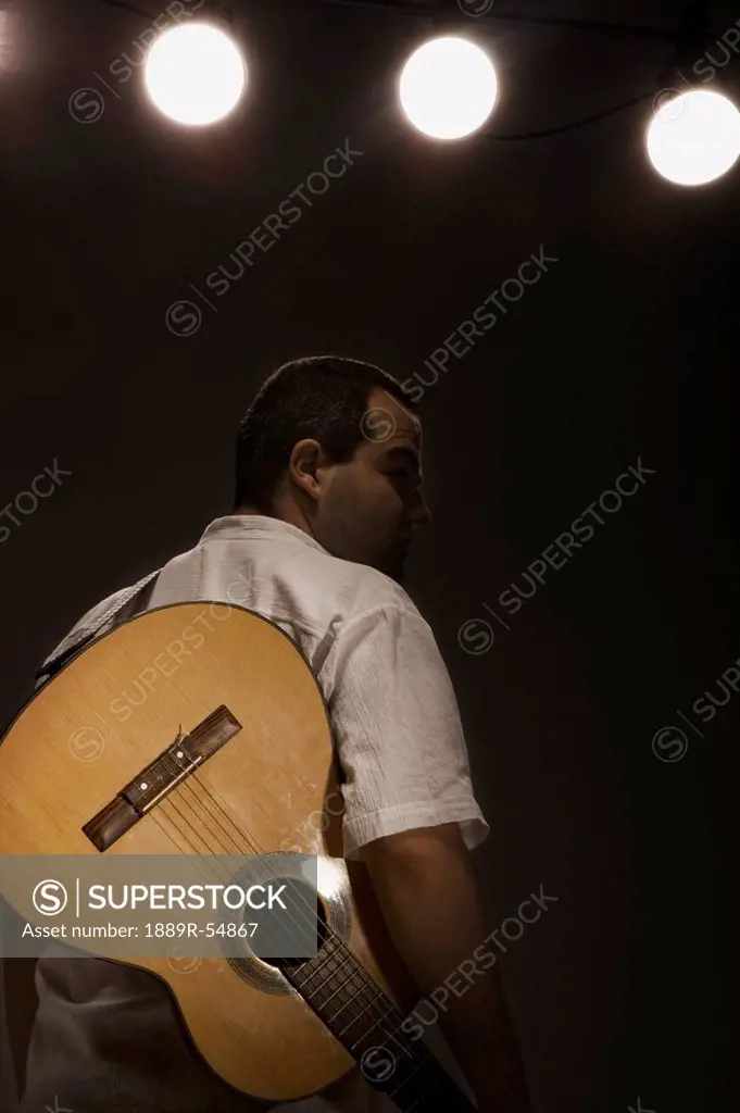 A Man With A Guitar On A Strap