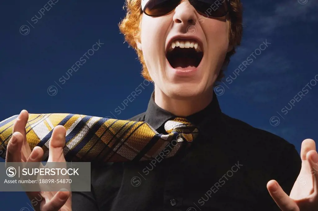 An Excited Young Man Wearing Sunglasses And A Necktie