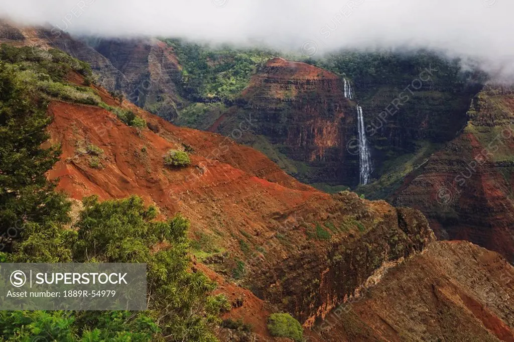 Kauai, Hawaii, United States Of America, Waipo´o Falls In Waimea Canyon Under A Lifting Cloud Layer