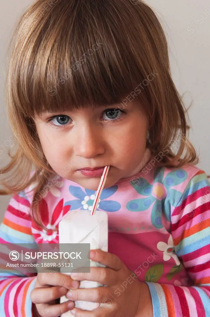 cadiz, spain, a young girl drinks from a straw