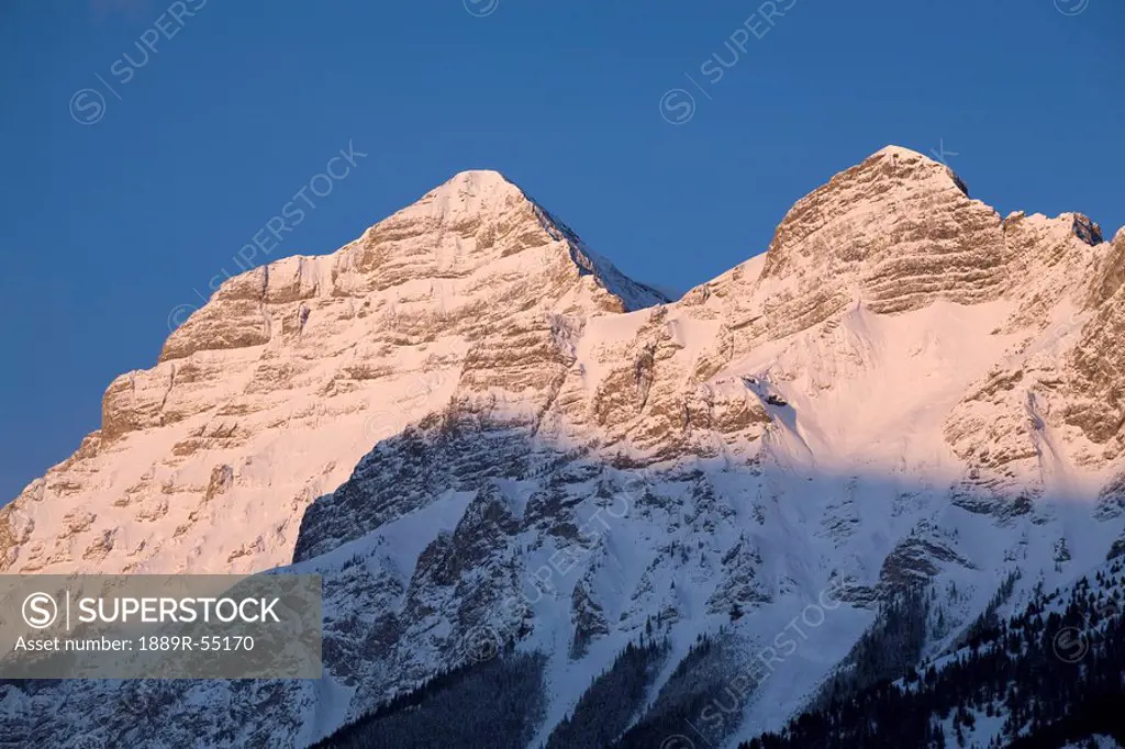 alberta, canada, snow covered mountain peaks at sunrise in kananaskis country