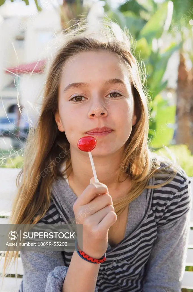 a girl holding a lollipop