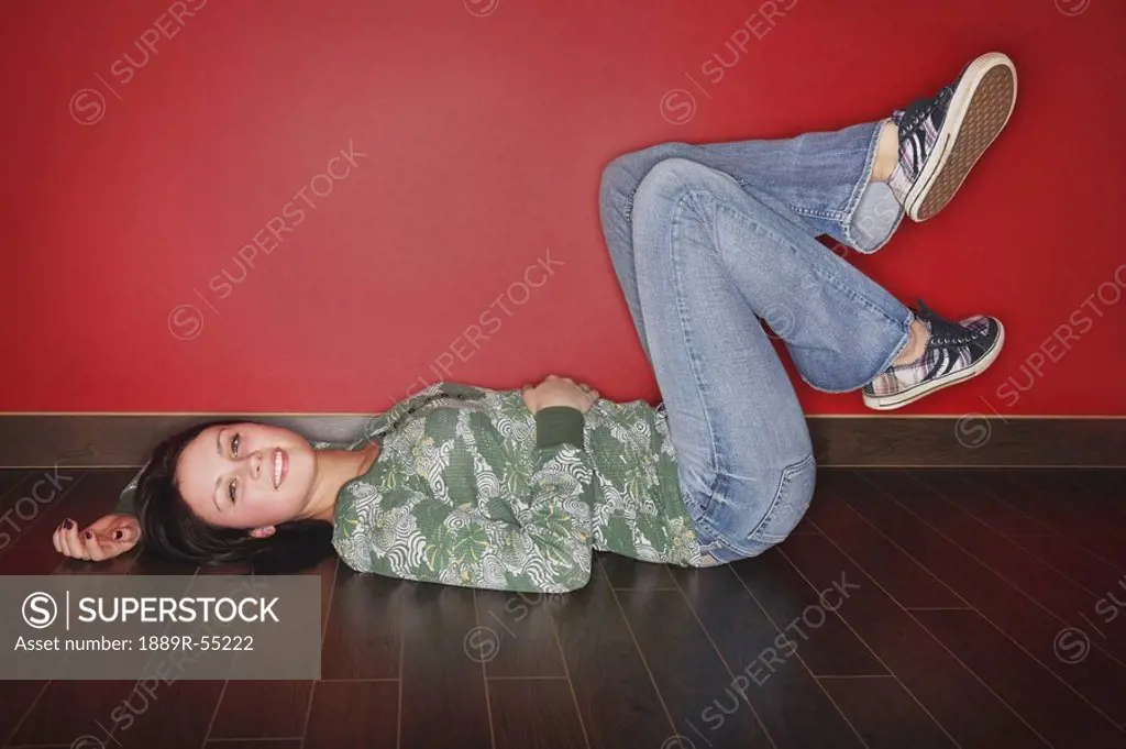 a young woman laying on the floor