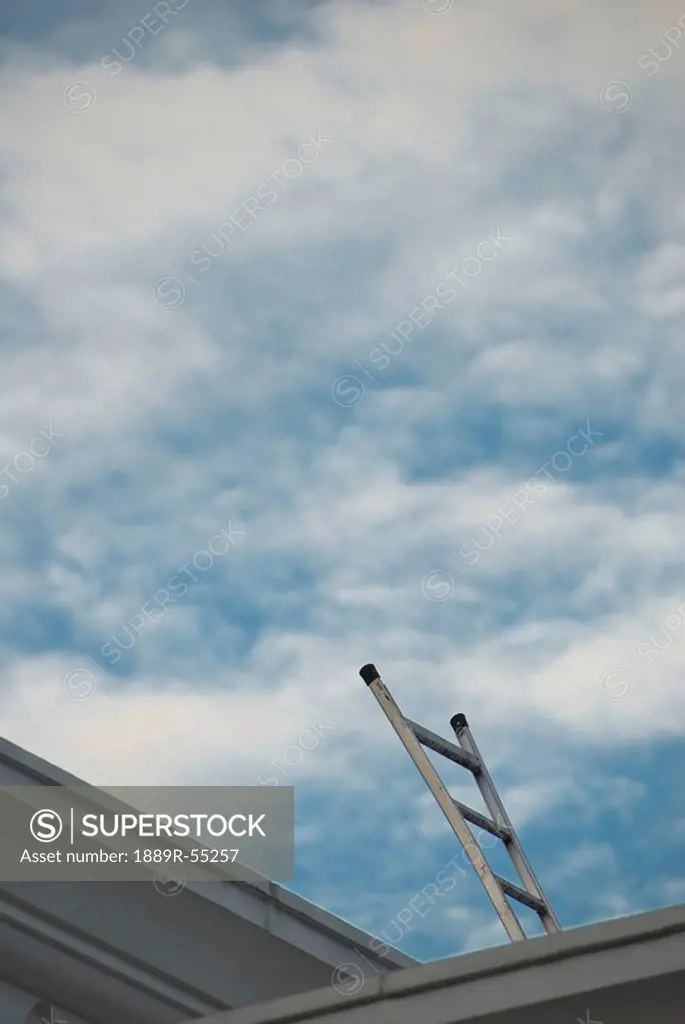 kuala lumpur, malaysia, a metal ladder on a roof reaching to the sky