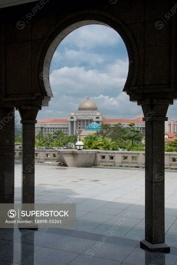 kuala lumpur, malaysia, view of a building through an archway and columns