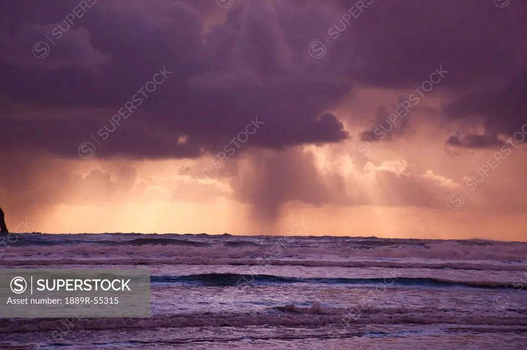 oregon, united states of america, storm clouds over the water at sunset