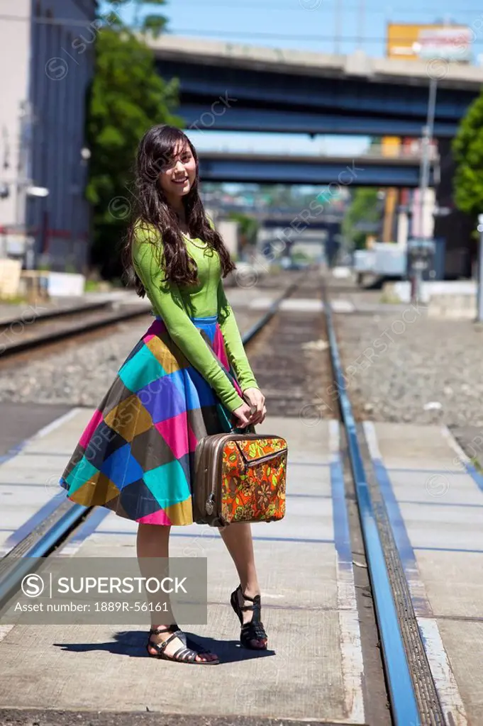 teenage girl on the train tracks downtown, portland, oregon, united states of america