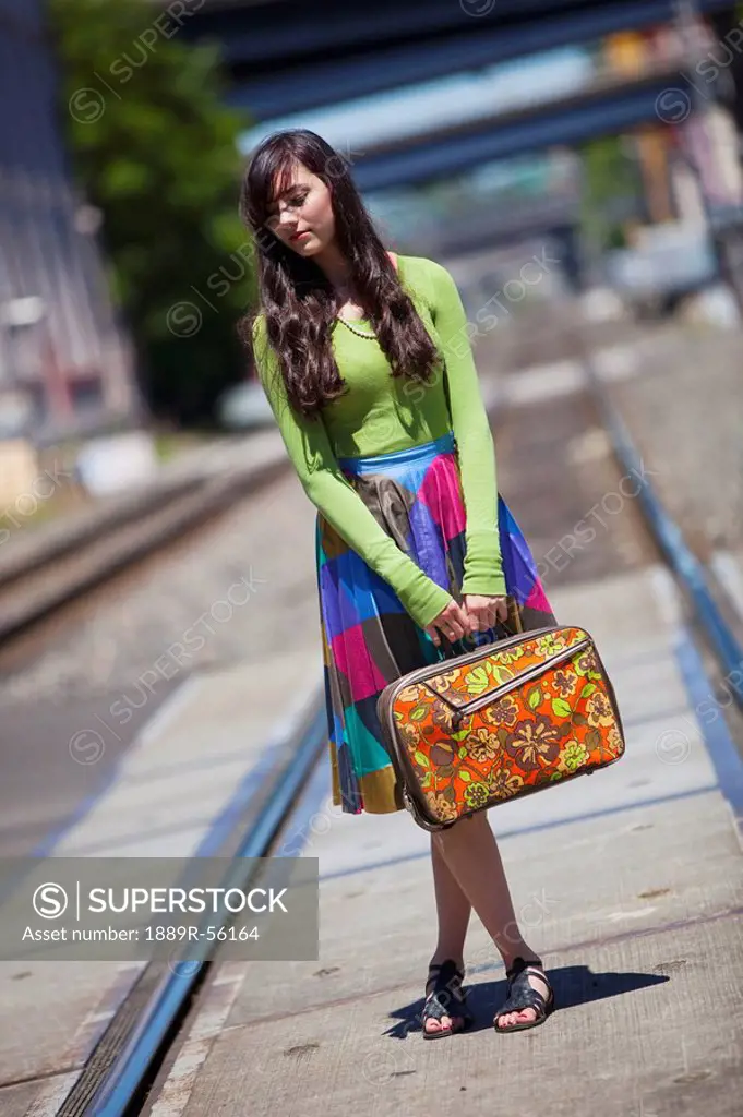 teenage girl on the train tracks downtown, portland, oregon, united states of america