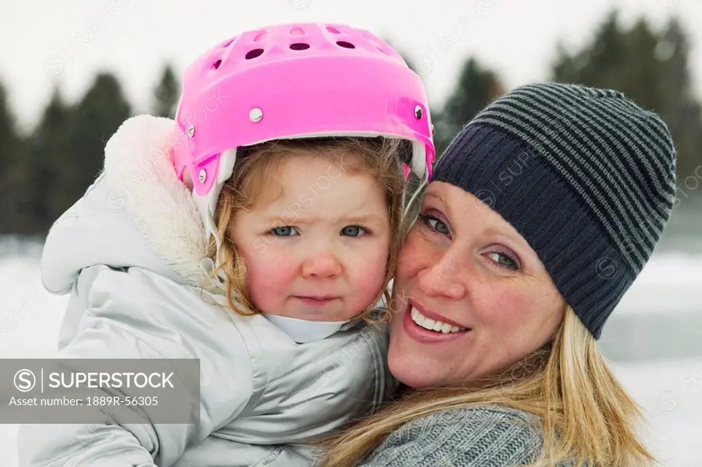 edmonton, alberta, canada, a mother and daughter on an outdoor ice rink