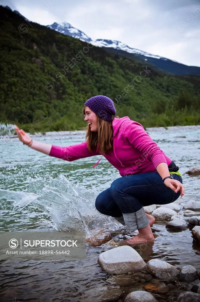 skagway, alaska, united states of america, a woman splashing and playing in the water