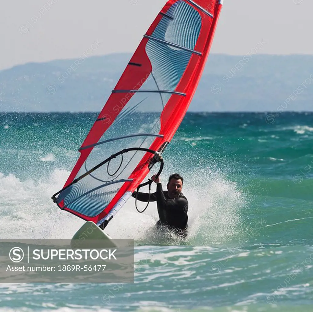 tarifa, cadiz, andalusia, spain, a man windsurfing