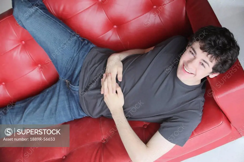 teenage boy relaxing on the sofa