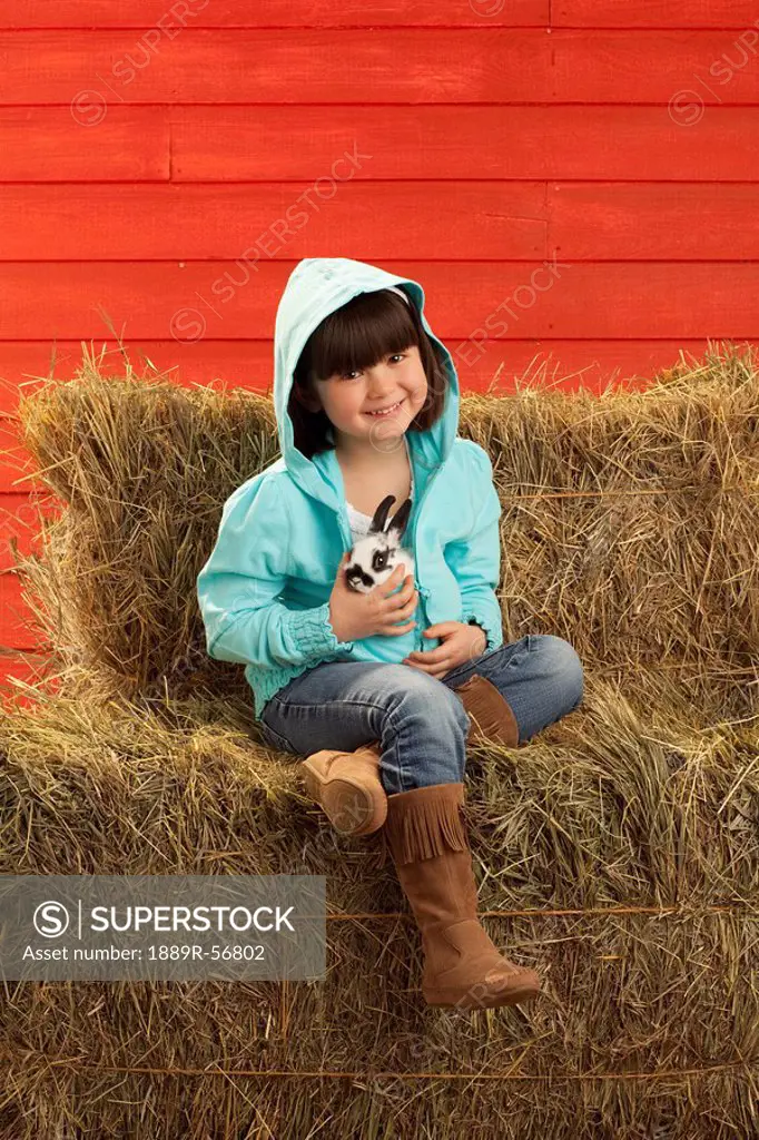 three hills, alberta, canada, a young girl holding a bunny rabbit
