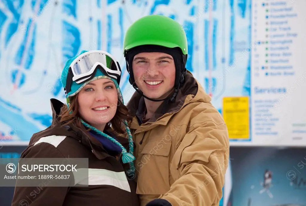 red deer, alberta, canada, a man and woman wearing a helmet and ski mask at a ski area