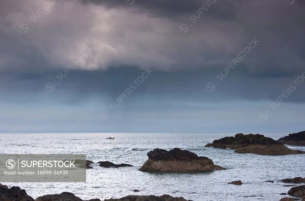 st. abb´s head, scottish borders, scotland, large rocks in the water under dark clouds