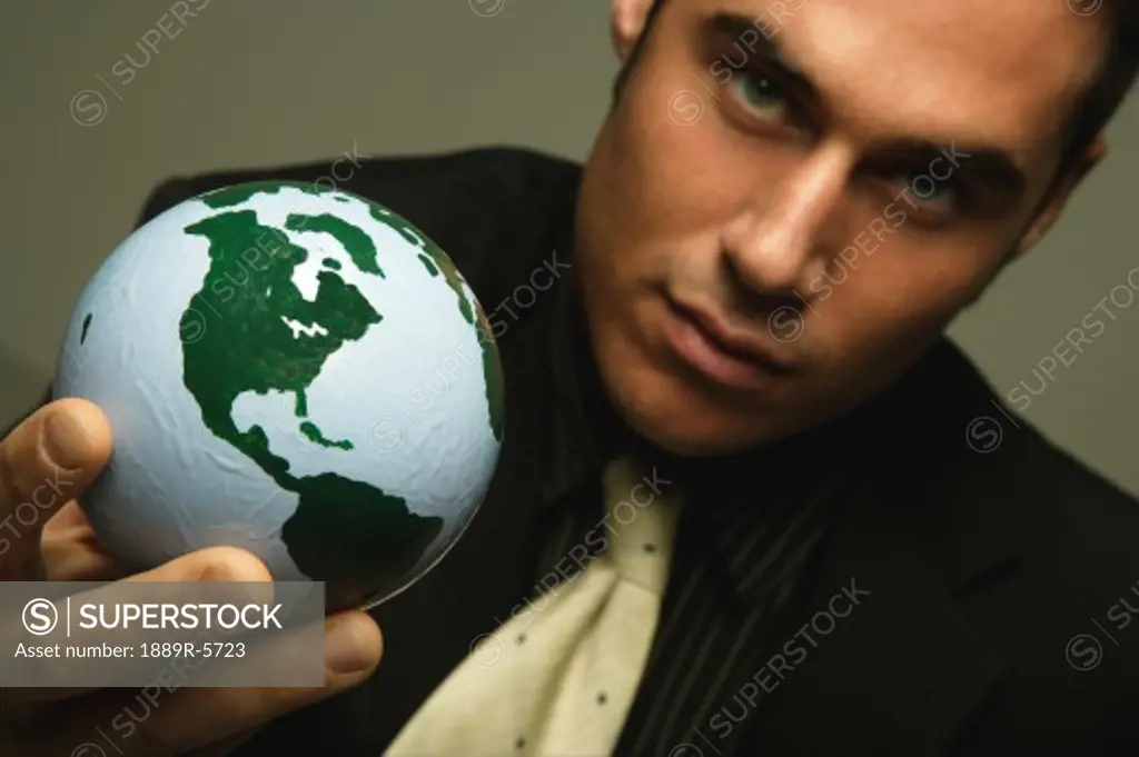 Businessman holds the world in his hand