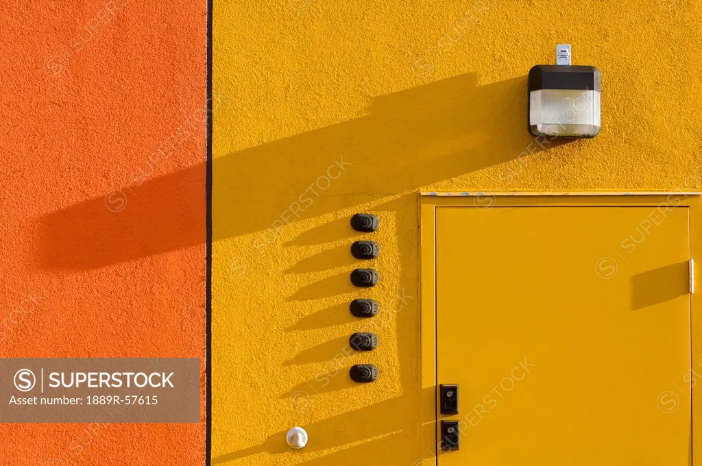 orange and yellow stucco door with a door and a light, st. albert, alberta, canada