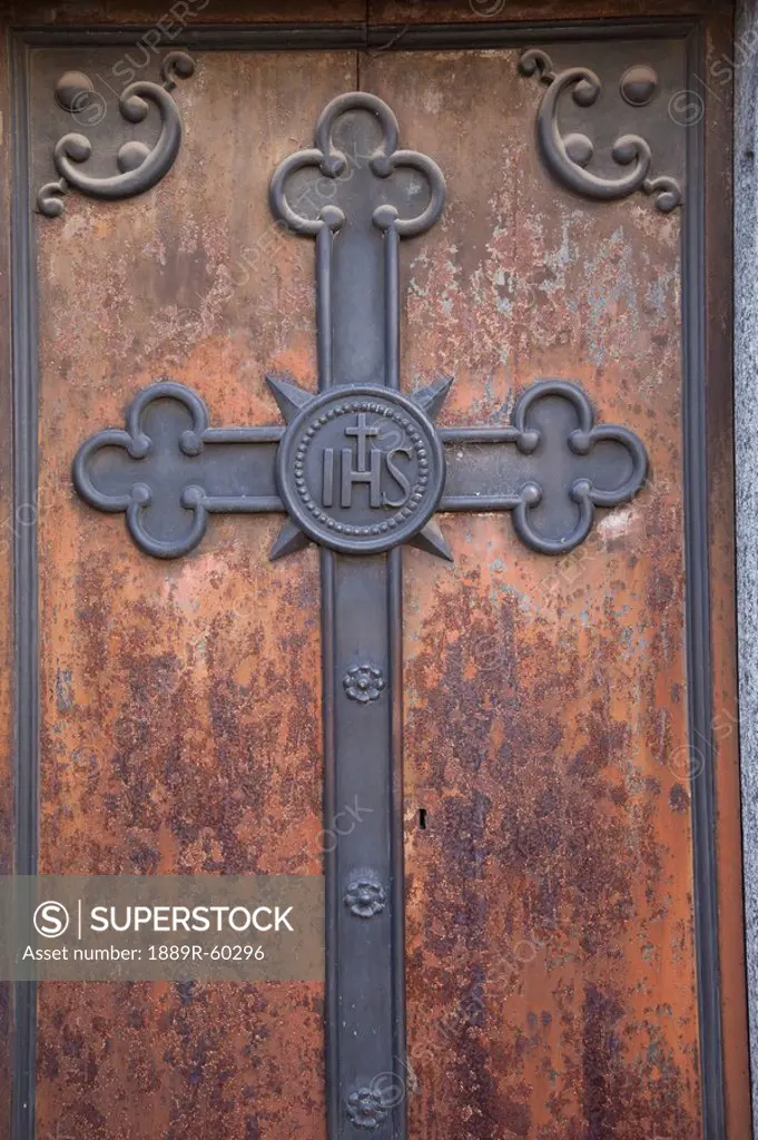 Buenos Aires, Argentina, A Metal Cross On A Wooden Door Of A Tomb In Recoleta Cemetery