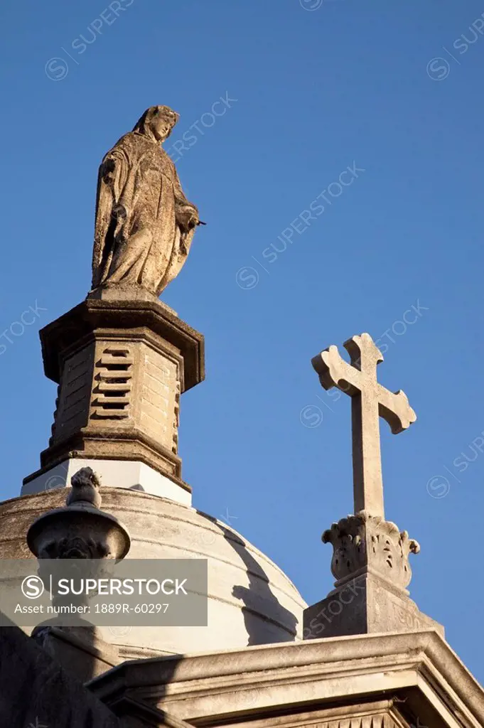 Buenos Aires, Argentina, Stone Cross And Statues On Tombs In Recoleta Cemetery