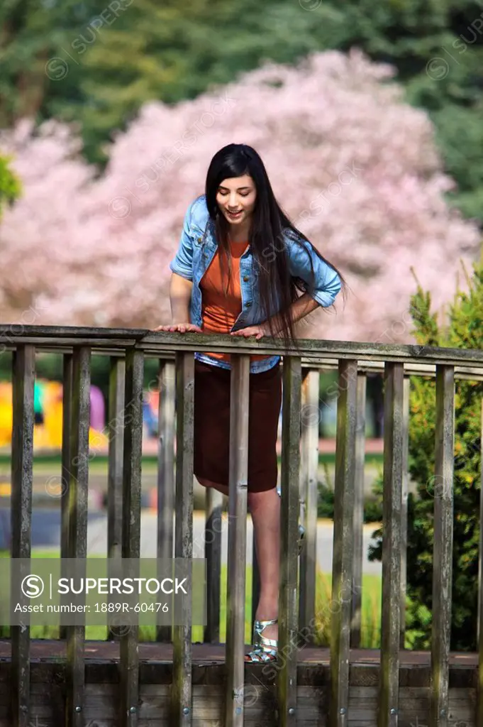 Portland, Oregon, United States Of America, A Teenage Girl Looking Down Over A Railing In Portland Park