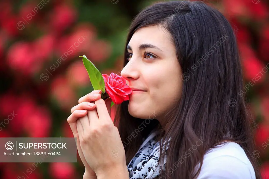 Portland, Oregon, United States Of America, A Teenage Girl Smelling A Flower In Portland Park