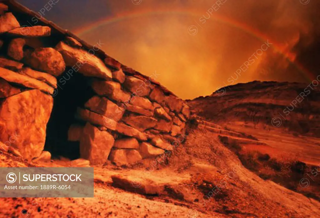 An empty tomb with a rainbow