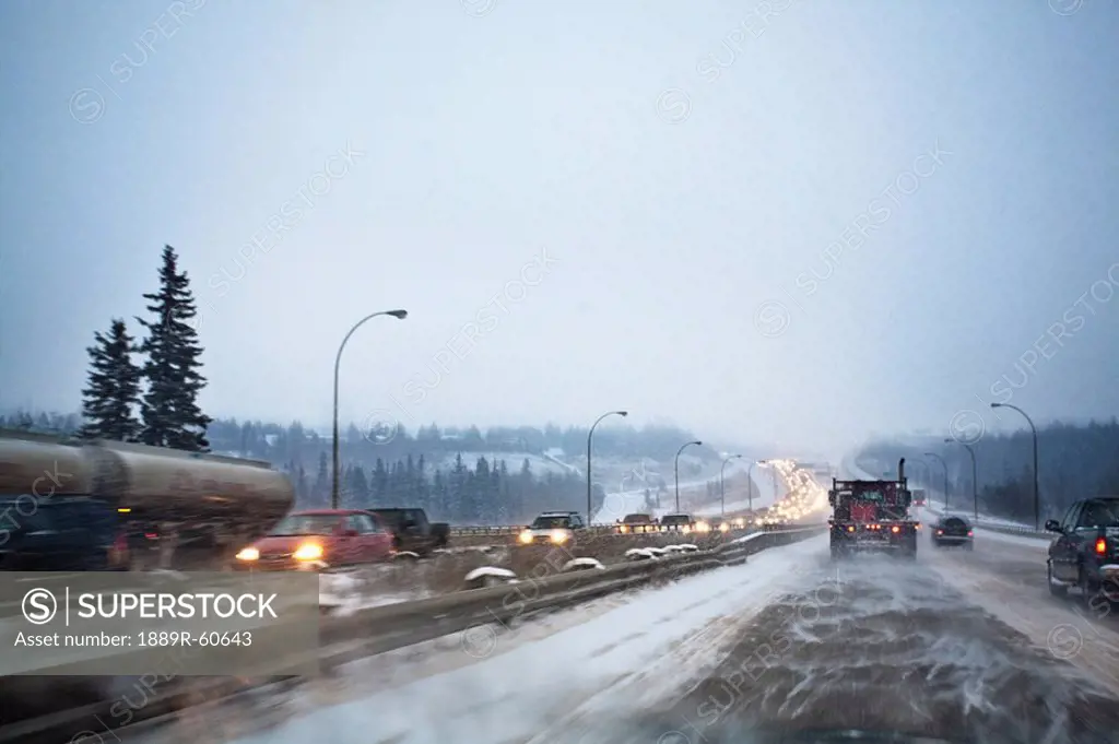 Edmonton, Alberta, Canada, Vehicles Traveling On The Road With Snow Blowing In Winter