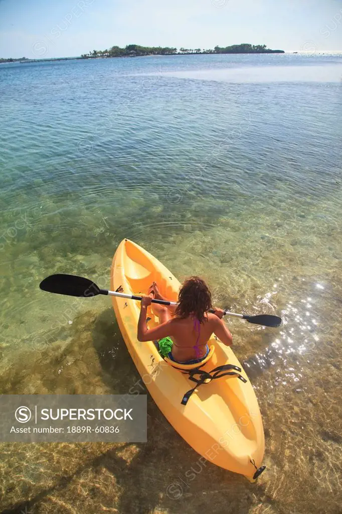 Roatan, Bay Islands, Honduras, A Young Woman Paddling A Kayak At Anthony´s Key Resort