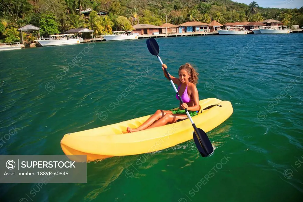 Roatan, Bay Islands, Honduras, A Young Woman Paddling A Kayak At Anthony´s Key Resort