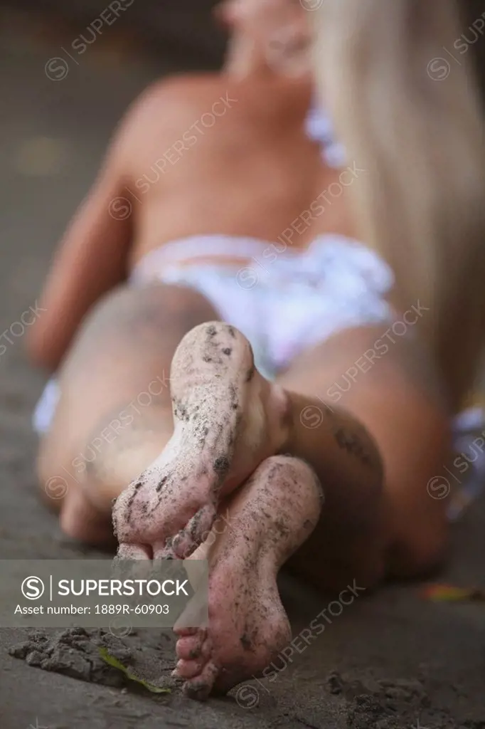 Grand Prairie, Alberta, Canada, A Woman´s Feet Covered In Sand While Laying On The Beach Wearing A Bathing Suit