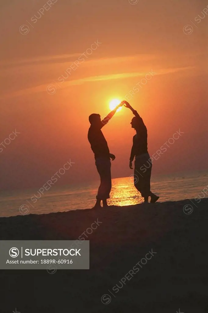 St. Catharines, Ontario, Canada, Silhouette Of A Couple Dancing On A Beach At Sunset
