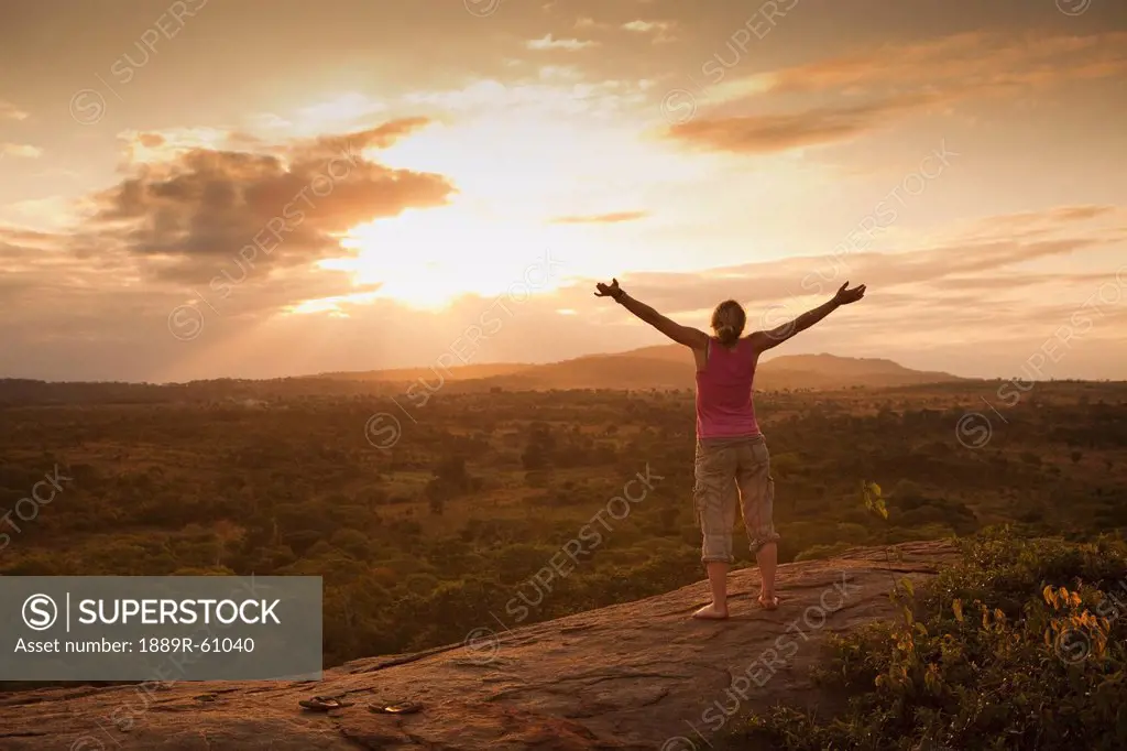 A Woman With Her Arms Raised To The Sky At Sunset, Manica, Mozambique, Africa