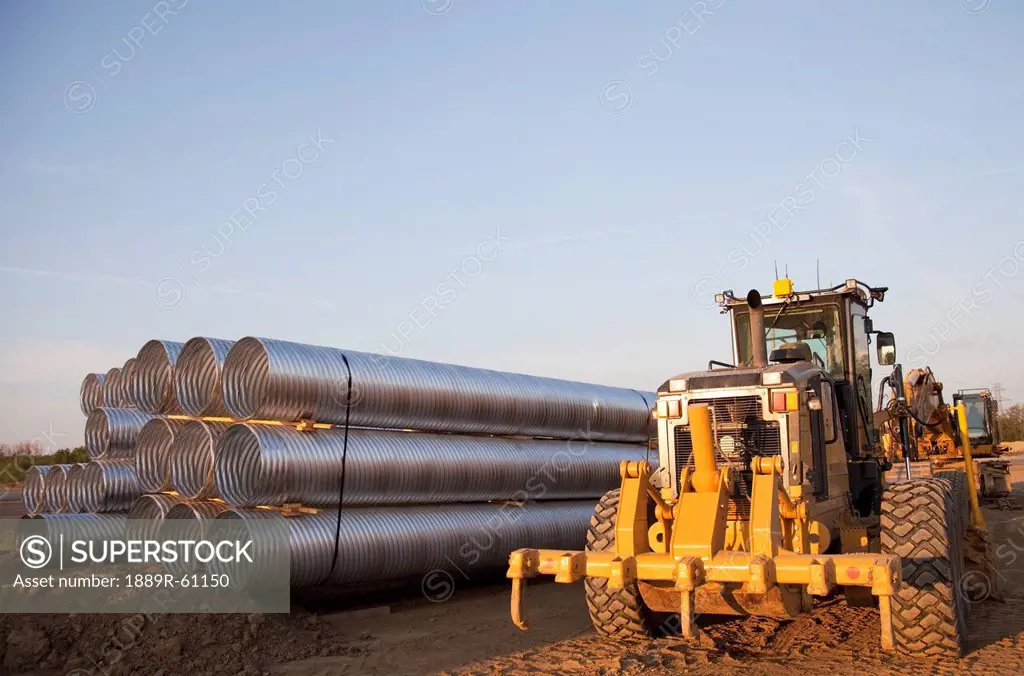 Road Construction Using A Grader And A Bundle Of Culvert Pipes, Edmonton, Alberta, Canada