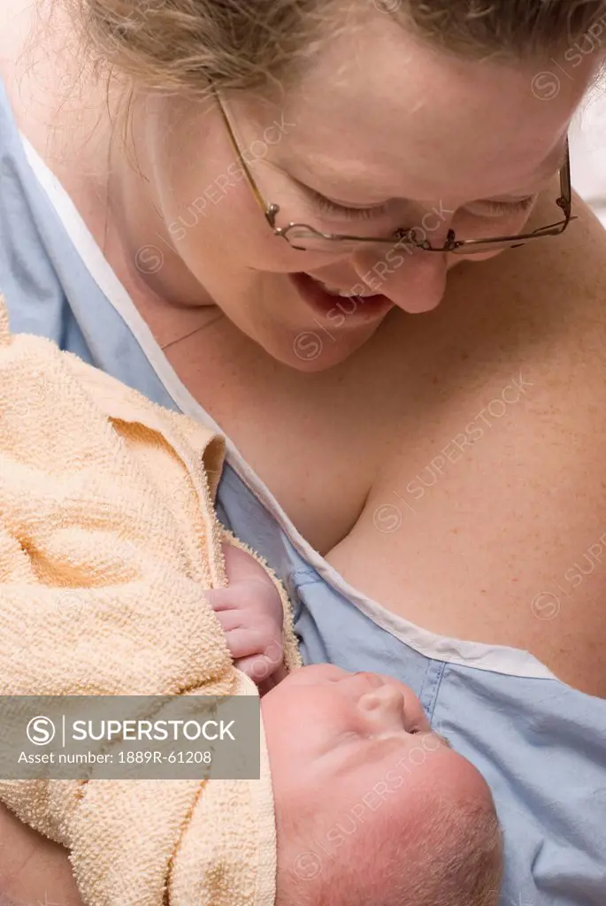 A Mother Holds Her Newborn Baby, Millet, Alberta, Canada