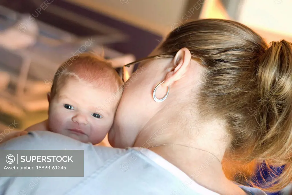 A Mother Holds And Kisses Her Newborn Baby, Millet, Alberta, Canada