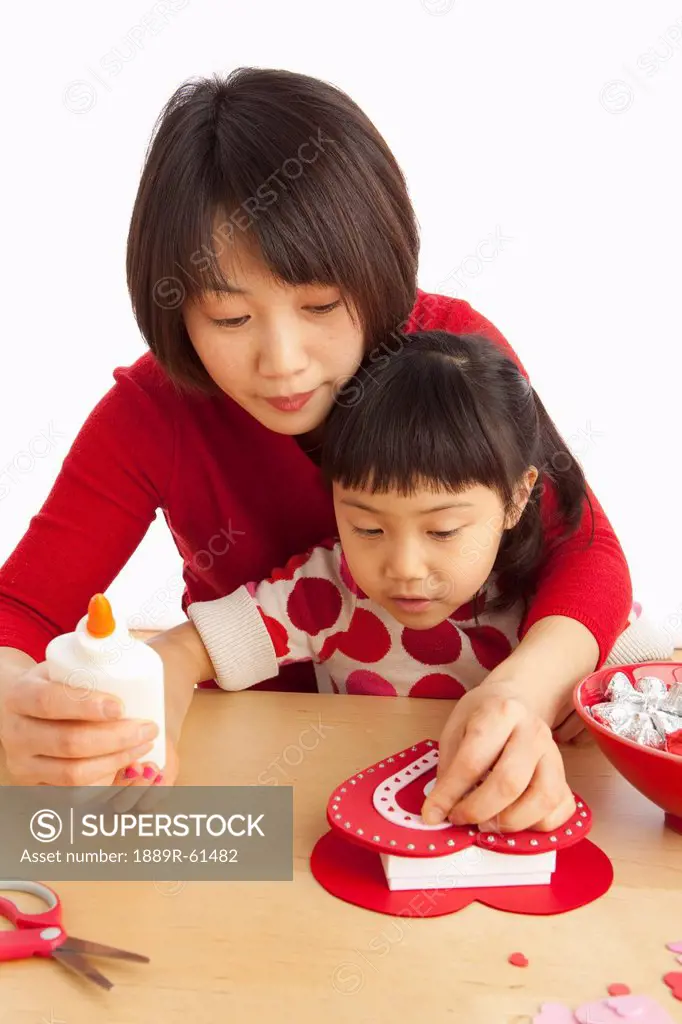 A Mother And Daughter Making A Valentine´s Day Craft
