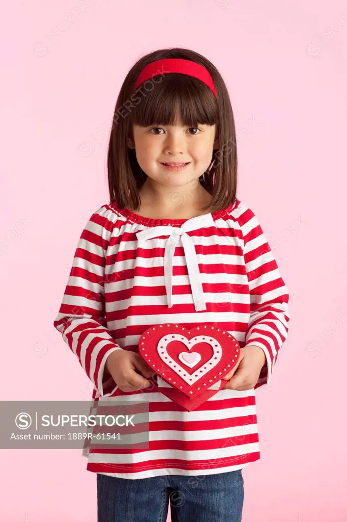 A Girl Holding A Heart Shaped Box