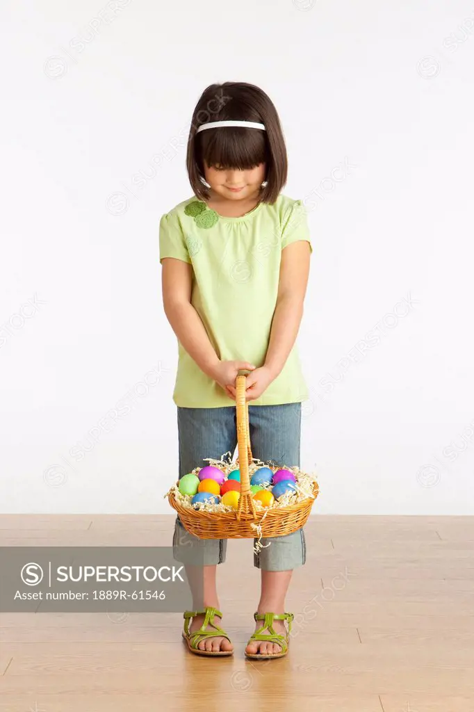 A Girl Holding A Basket Of Easter Eggs