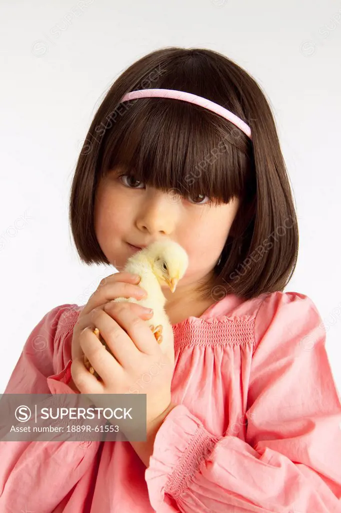 A Girl Holding A Chick