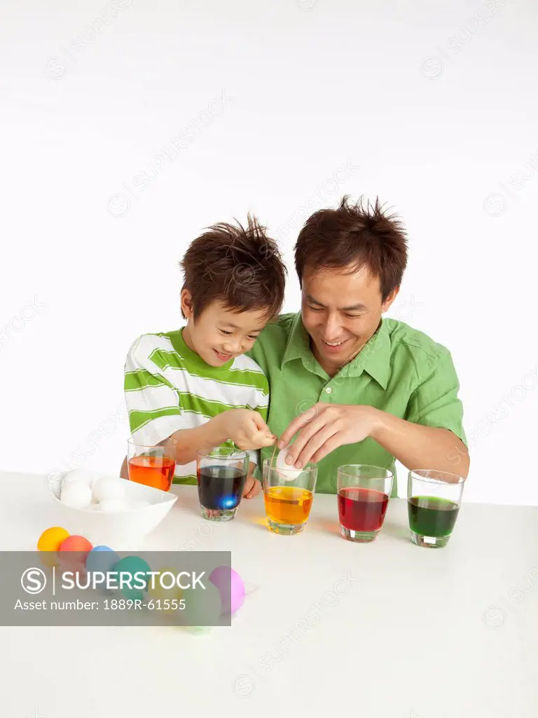 A Boy And His Father Dying Easter Eggs